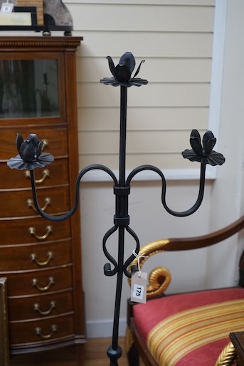 A wrought iron tripod pricket candle stand, height 140cm